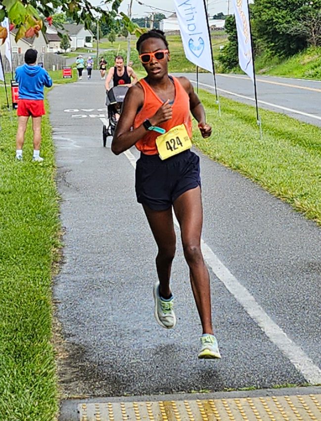 Girl in pink tank top running.